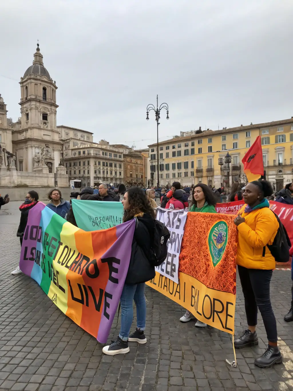 A powerful image of activists participating in a community event, holding signs and engaging in dialogue, organized by MAISON DE LA to promote social awareness.